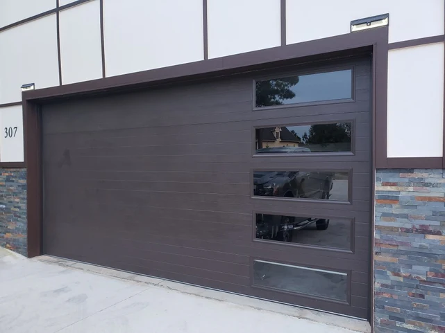 Mundo – Flush Panel Steel with a Natural Wood-Grain Texture Garage Door and Vertical Windows